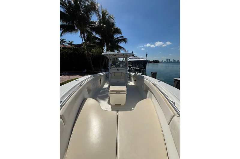 Slide: The Image of 2006 Hydra-Sports Vector 3300 CC boat docked by palm trees and waterfront. - 6