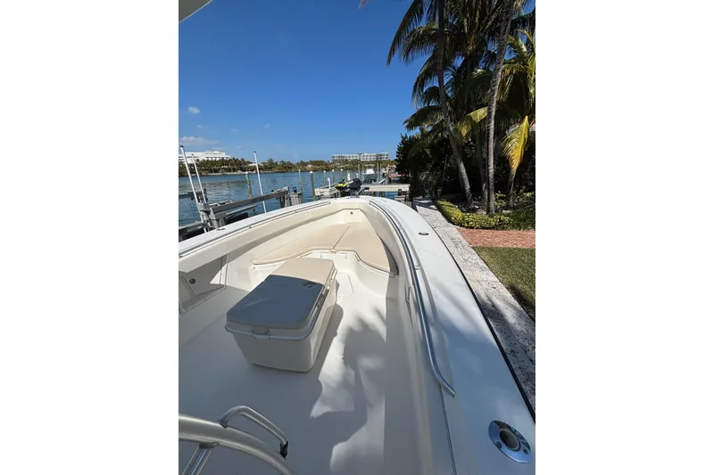 Slide: The Image of 2006 Hydra-Sports Vector 3300 CC boat docked by palm trees and waterfront. - 7
