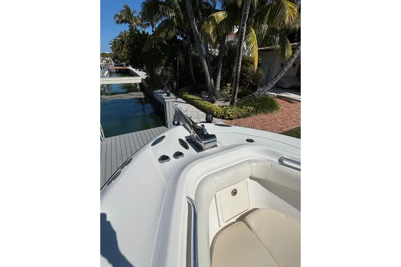Slide: The Image of 2006 Hydra-Sports Vector 3300 CC boat docked near palm trees and waterfront. - 8