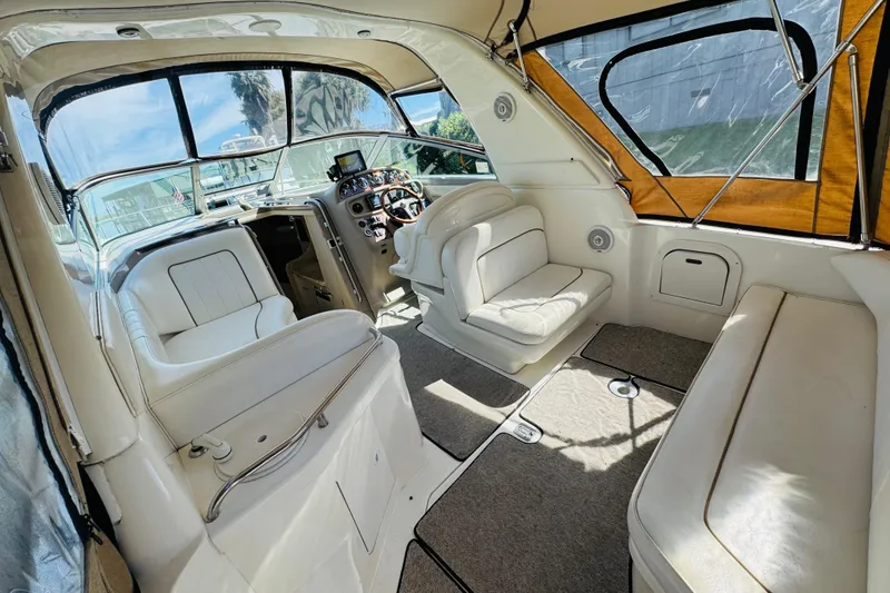 Slide: The Image of Interior of 2000 Sea Ray 290 Sundancer boat with white seating and helm. - 17