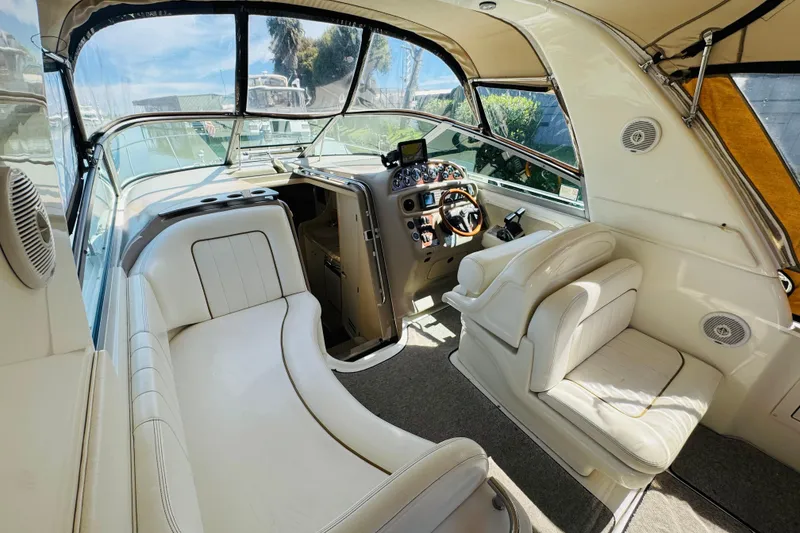 Slide: The Image of Interior of 2000 Sea Ray 290 Sundancer boat with white seating and control panel. - 19