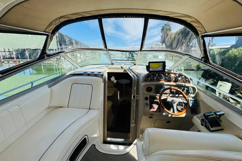 Slide: The Image of Interior view of 2000 Sea Ray 290 Sundancer boat cockpit with steering wheel and controls. - 21
