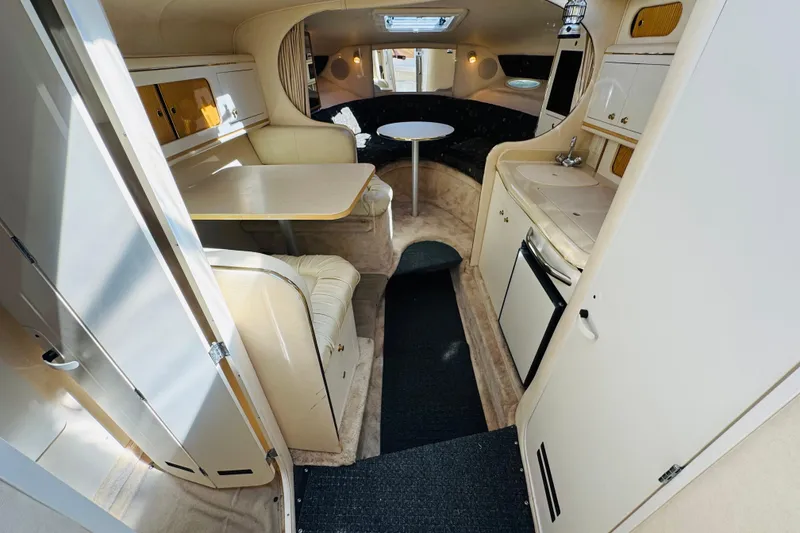 Slide: The Image of Interior of 2000 Sea Ray 290 Sundancer boat with kitchenette and seating area. - 30