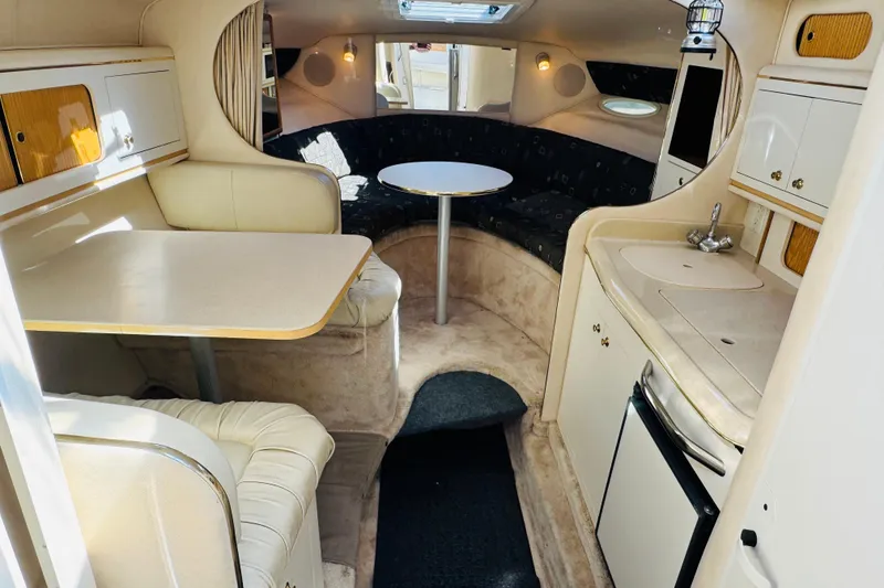 Slide: The Image of Interior of a 2000 Sea Ray 290 Sundancer boat with seating and kitchenette. - 31