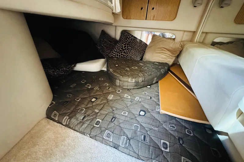 Slide: The Image of Cozy cabin interior of 2000 Sea Ray 290 Sundancer with patterned cushions and pillows. - 39
