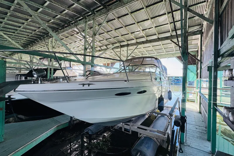 Slide: The Image of 2000 Sea Ray 290 Sundancer boat docked in a covered marina. - 4