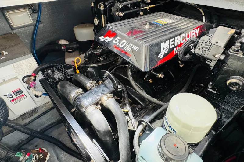 Slide: The Image of Engine compartment of a 2000 Sea Ray 290 Sundancer with a 5.0L Mercury motor. - 43