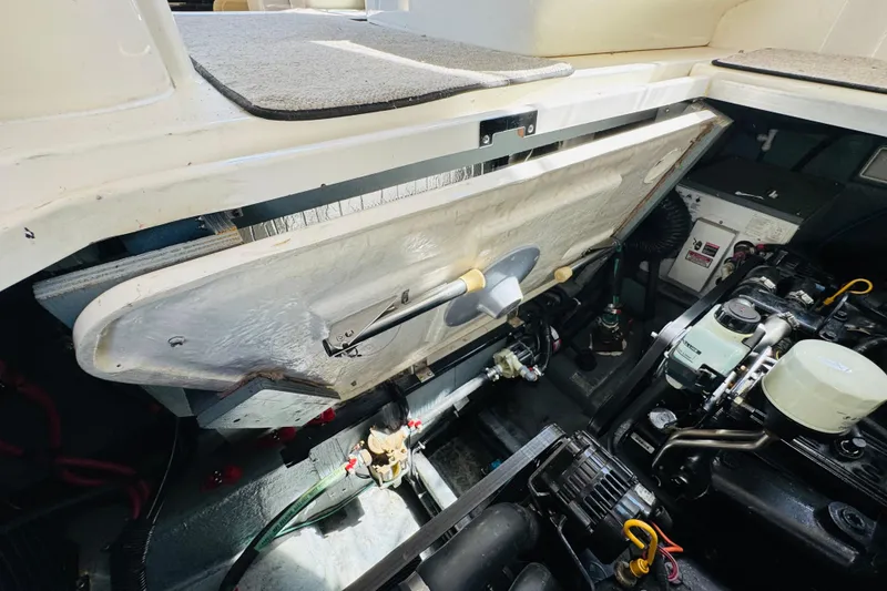 Slide: The Image of Engine compartment of a 2000 Sea Ray 290 Sundancer boat, showcasing mechanical components. - 44
