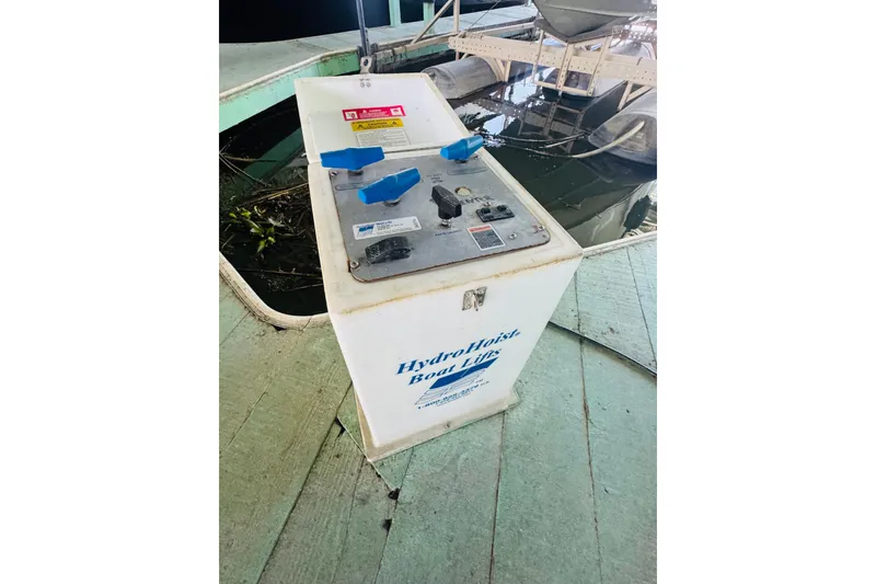 Slide: The Image of Control panel for HydroHoist boat lift near water, associated with 2000 Sea Ray 290 Sundancer. - 46