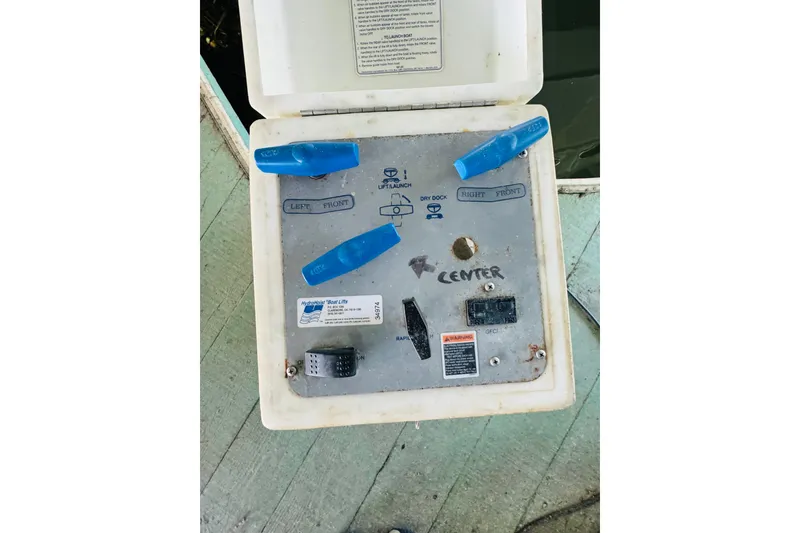 Slide: The Image of Control panel for boat lift system, featuring blue levers and labeled instructions. - 47