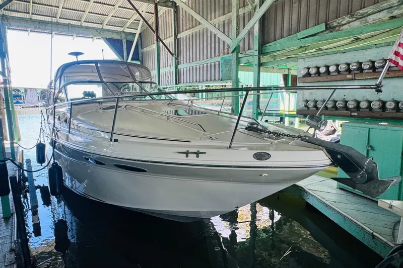 Slide: The Image of 2000 Sea Ray 290 Sundancer docked in a covered marina, showcasing sleek design and craftsmanship. - 8