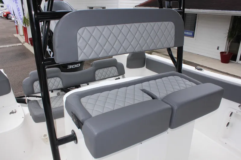 Slide: The Image of 2024 Clearwater 2300 CC boat with gray cushioned seating and sleek design. - 21