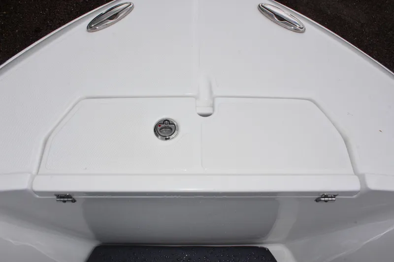 Slide: The Image of 2024 Clearwater 2300 CC boat deck with storage compartment and stainless steel fixtures. - 26