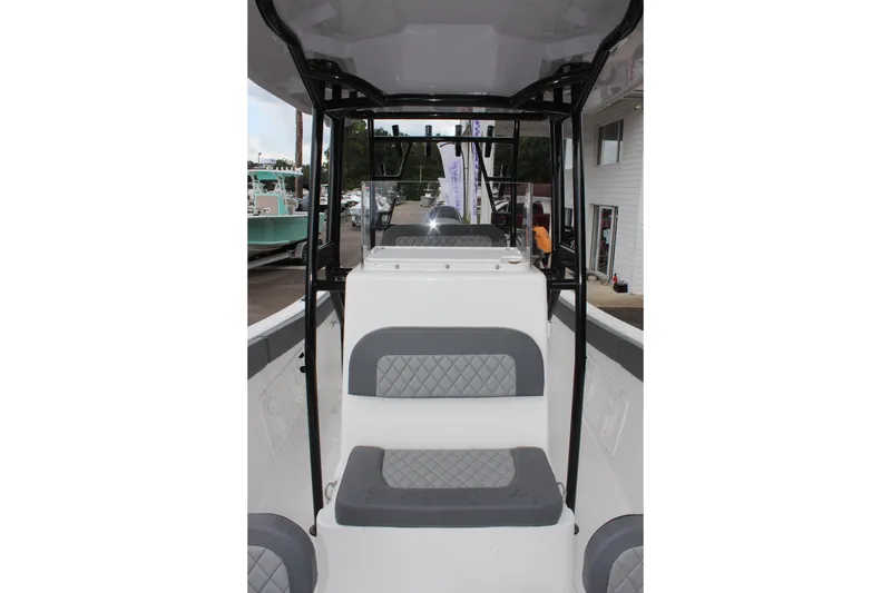 Slide: The Image of 2024 Clearwater 2300 CC boat interior with gray seating and black frame. - 28