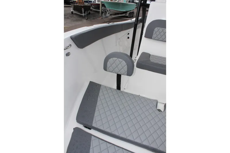 Slide: The Image of 2024 Clearwater 2300 CC boat interior with gray cushioned seating and flooring. - 29
