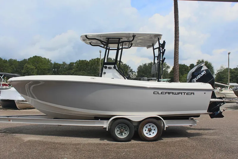 The Image of 2024 Clearwater 2300 CC boat on trailer, side view, outdoors. - 1
