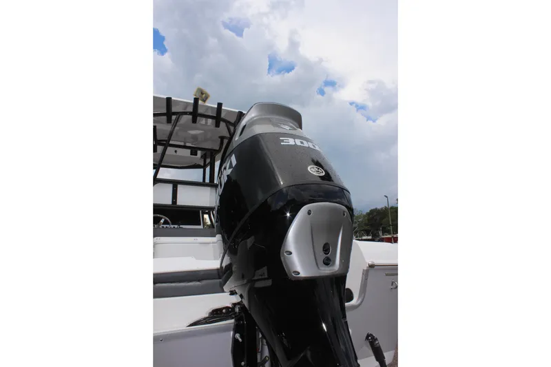 Slide: The Image of 2024 Clearwater 2300 CC boat with powerful outboard motor under cloudy sky. - 10