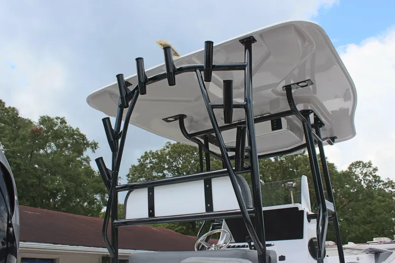 Slide: The Image of 2024 Clearwater 2300 CC boat with T-top and rod holders, under a cloudy sky. - 11