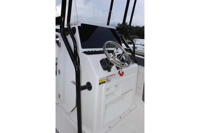 Slide: The Image of 2024 Clearwater 2300 CC boat console with steering wheel and controls. - 17