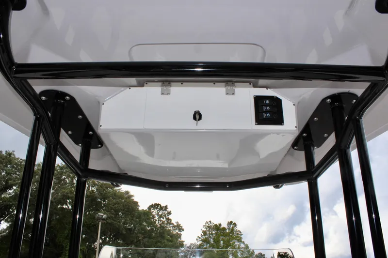 Slide: The Image of 2024 Clearwater 2300 CC boat console with black frame and control panel. - 18