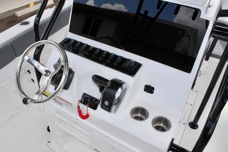 Slide: The Image of 2024 Clearwater 2300 CC boat console with steering wheel and controls. - 20