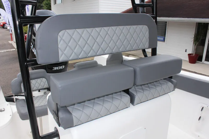 Slide: The Image of 2024 Clearwater 2300 CC boat with gray diamond-stitched seating and black frame. - 22