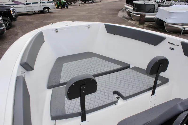 Slide: The Image of 2024 Clearwater 2300 CC boat interior with gray seating and diamond-patterned cushions. - 23
