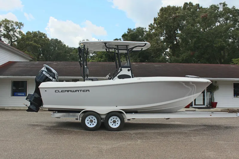 Slide: The Image of 2024 Clearwater 2300 CC boat on trailer, parked outdoors, side view. - 5
