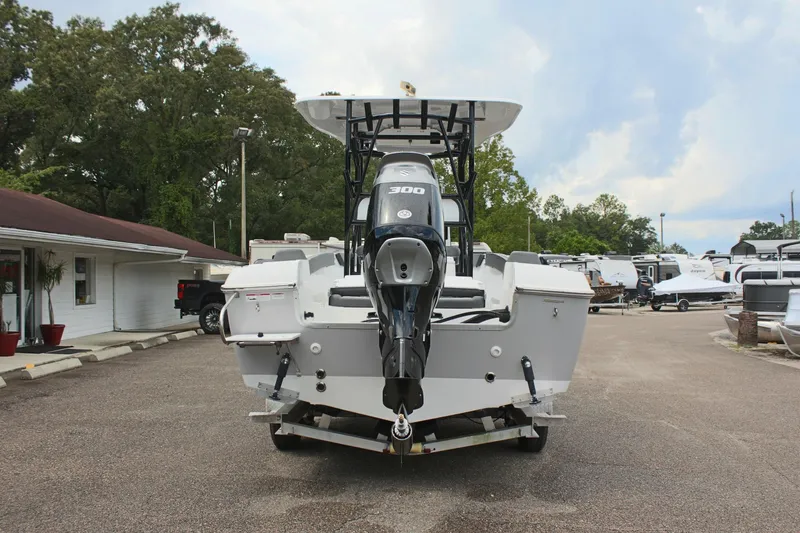 Slide: The Image of 2024 Clearwater 2300 CC boat with powerful outboard motor, parked outdoors. - 7