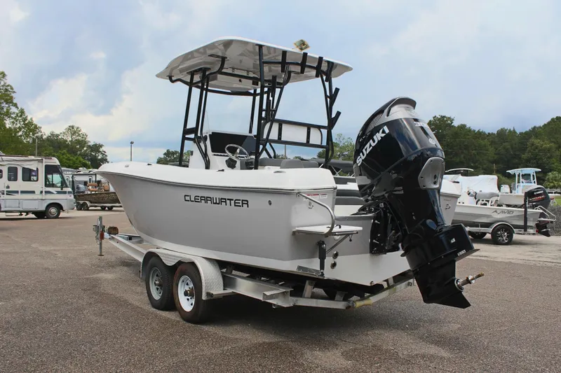 Slide: The Image of 2024 Clearwater 2300 CC boat on trailer with Suzuki outboard motor. - 8