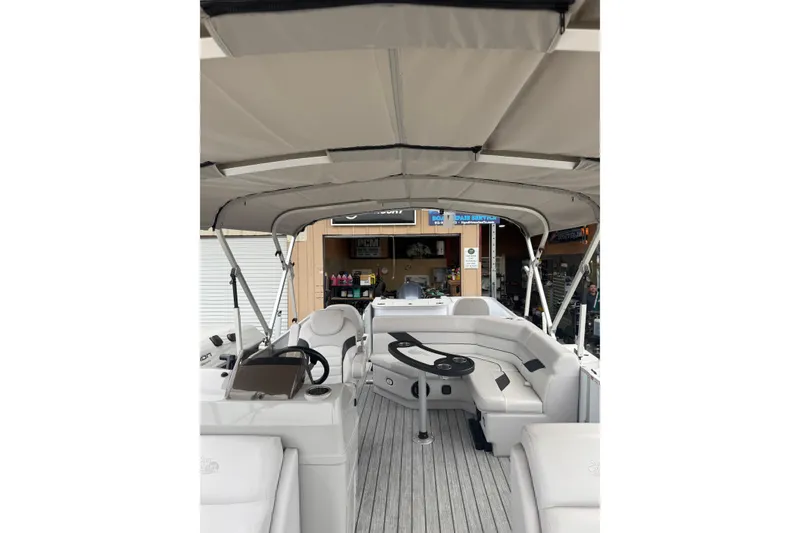 Slide: The Image of 2022 G3 Suncatcher Select 322RF pontoon boat interior with seating and steering console. - 10