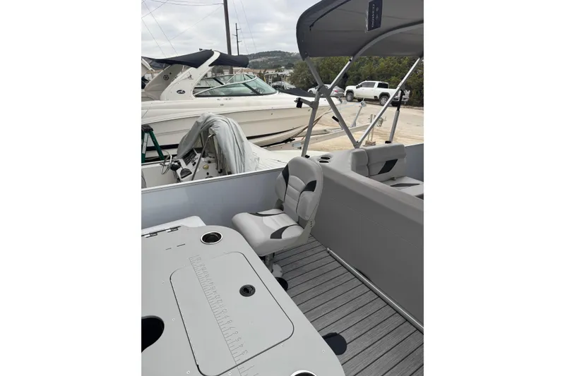 Slide: The Image of 2022 G3 Suncatcher Select 322RF pontoon boat interior with seating and table. - 11