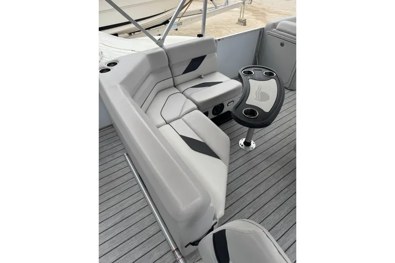 Slide: The Image of 2022 G3 Suncatcher Select 322RF boat interior with gray seating and table. - 13