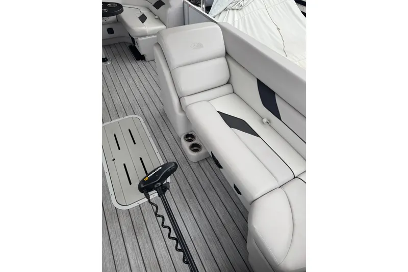 Slide: The Image of 2022 G3 Suncatcher Select 322RF boat interior with plush seating and sleek flooring. - 18