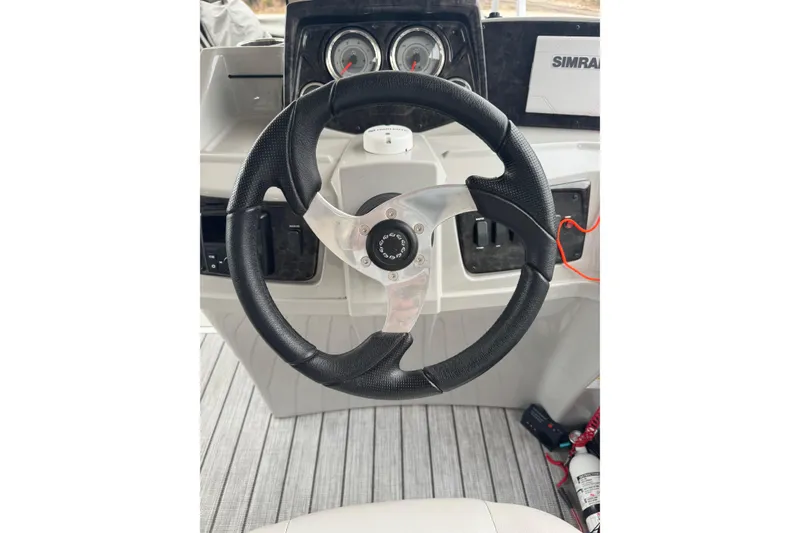Slide: The Image of Steering wheel of 2022 G3 Suncatcher Select 322RF boat with dashboard instruments. - 21