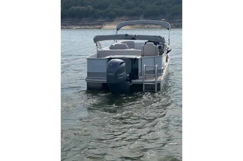 Slide: The Image of 2022 G3 Suncatcher Select 322RF pontoon boat on water, rear view. - 3