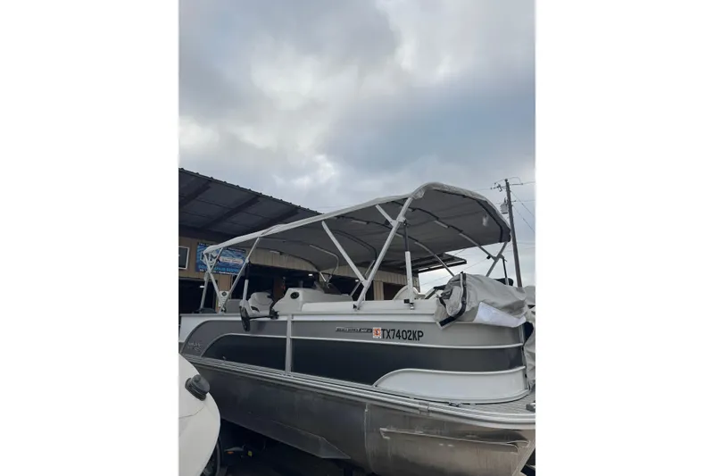 Slide: The Image of 2022 G3 Suncatcher Select 322RF pontoon boat under cloudy sky. - 4