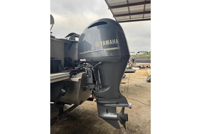 Slide: The Image of 2022 G3 Suncatcher Select 322RF with Yamaha outboard motor in a covered area. - 6