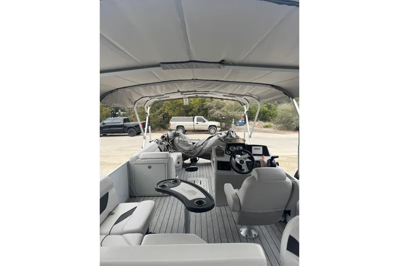 Slide: The Image of 2022 G3 Suncatcher Select 322RF pontoon boat interior with seating and steering console. - 9