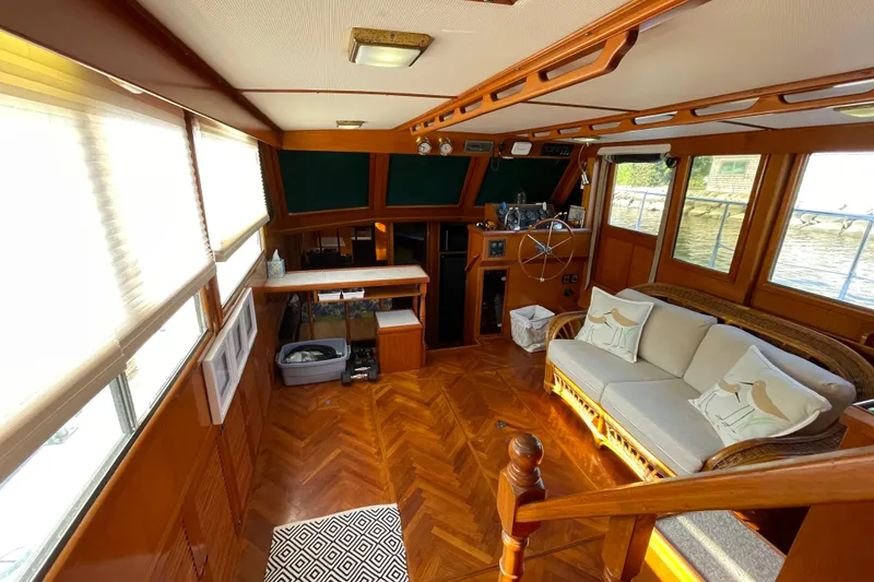 Slide: The Image of Interior of 1987 Heritage East 40 Sundeck yacht with wood finish and cozy seating. - 11