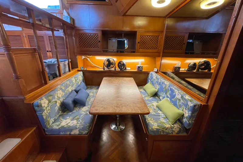 Slide: The Image of 1987 Heritage East 40 Sundeck interior with floral seating and wooden dining table. - 16