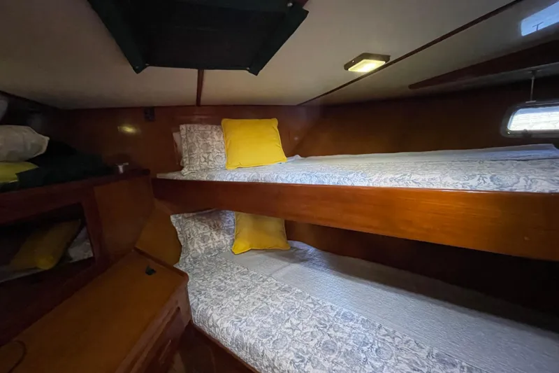 Slide: The Image of 1987 Heritage East 40 Sundeck interior with wooden bunk beds and yellow pillows. - 17