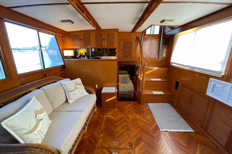 Slide: The Image of Interior of 1987 Heritage East 40 Sundeck yacht with wooden decor and cozy seating area. - 19