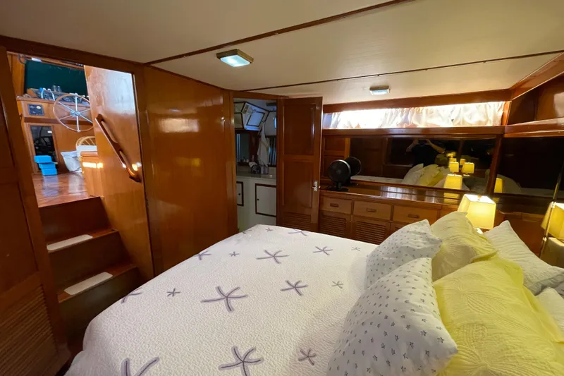 Slide: The Image of Cozy bedroom in 1987 Heritage East 40 Sundeck yacht with wooden interior and nautical decor. - 21