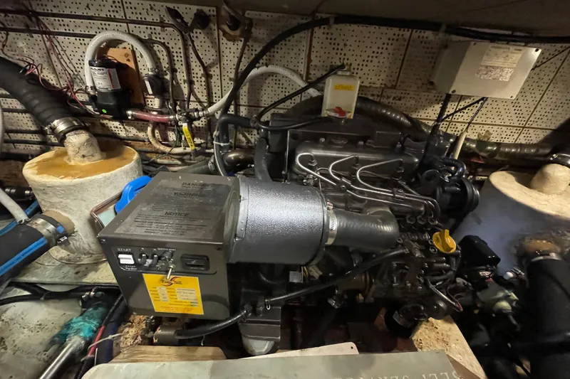 Slide: The Image of Engine room of a 1987 Heritage East 40 Sundeck boat, showcasing mechanical components. - 24
