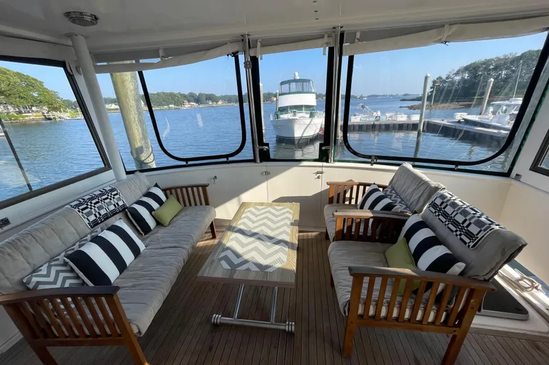 Slide: The Image of Interior of 1987 Heritage East 40 Sundeck yacht with comfortable seating and scenic marina view. - 4