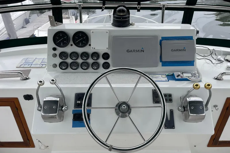 Slide: The Image of Helm of 1987 Heritage East 40 Sundeck with Garmin navigation equipment and dual throttle controls. - 8