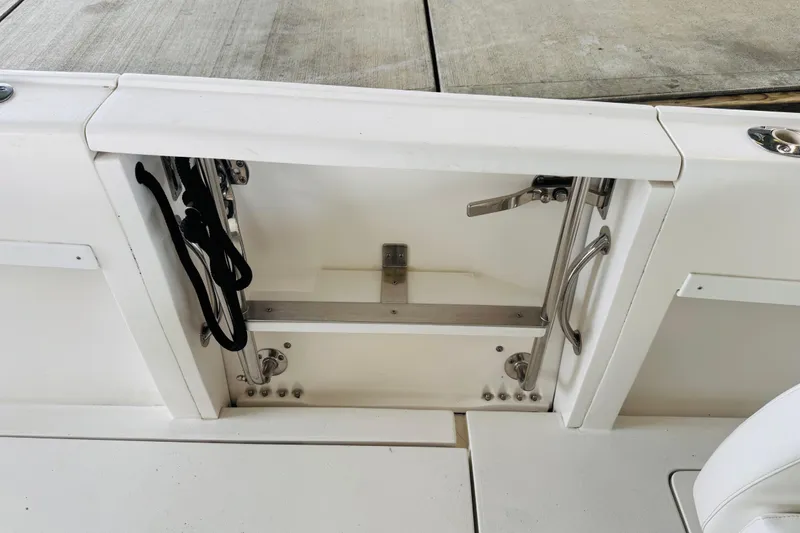 Slide: The Image of 2008 Intrepid 327 boat interior compartment with stainless steel fittings and storage space. - 16