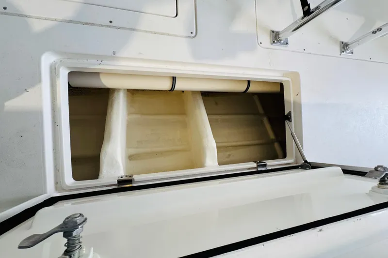 Slide: The Image of Open storage compartment on a 2008 Intrepid 327 boat, showcasing interior space. - 25