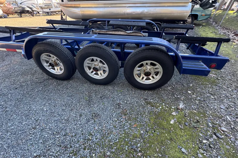 Slide: The Image of Blue triple-axle boat trailer on gravel, Intrepid 327, 2008 model. - 29